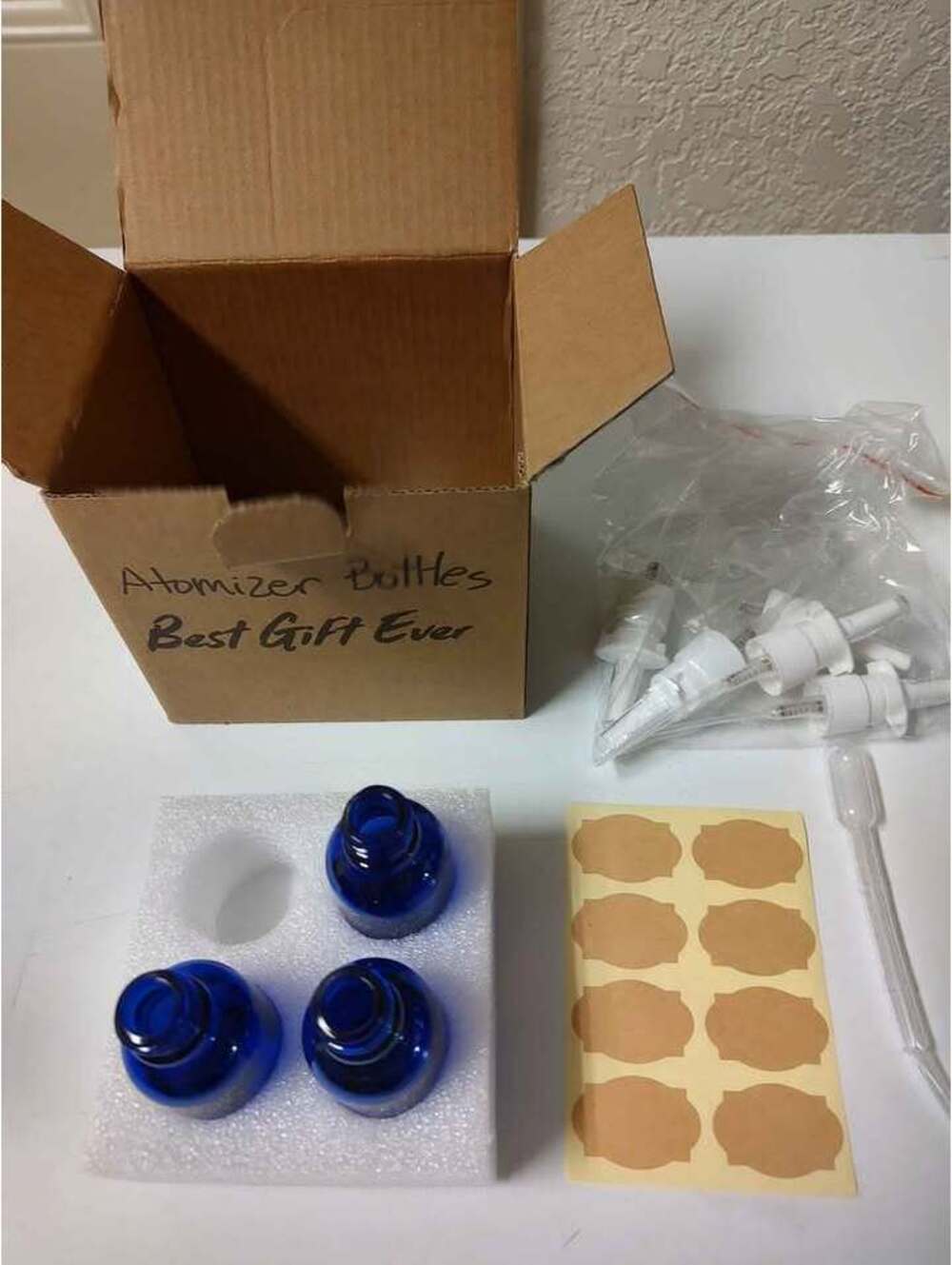 Three pack of blue atomizer bottles with five spray heads